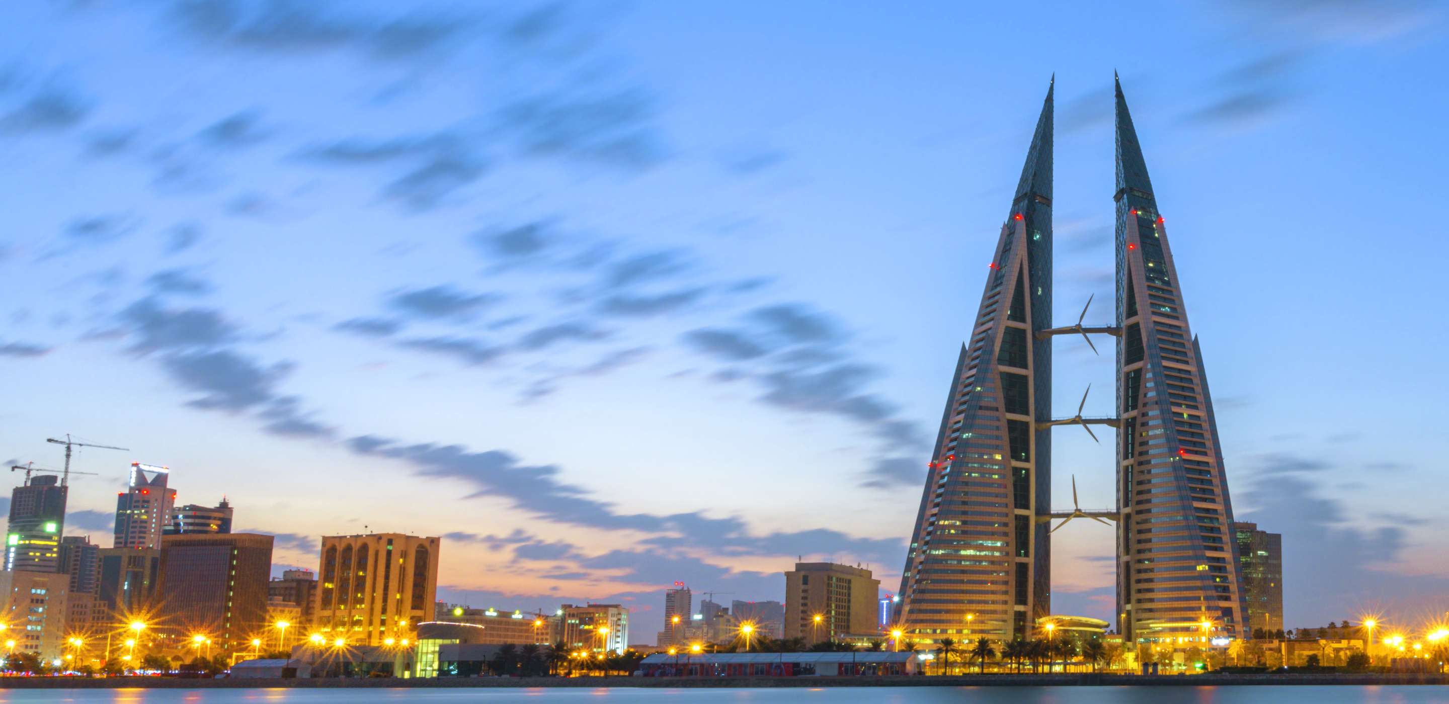 View of bahrain financing company building surrounded by water