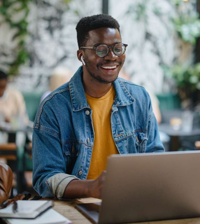 A man with earbuds smiling