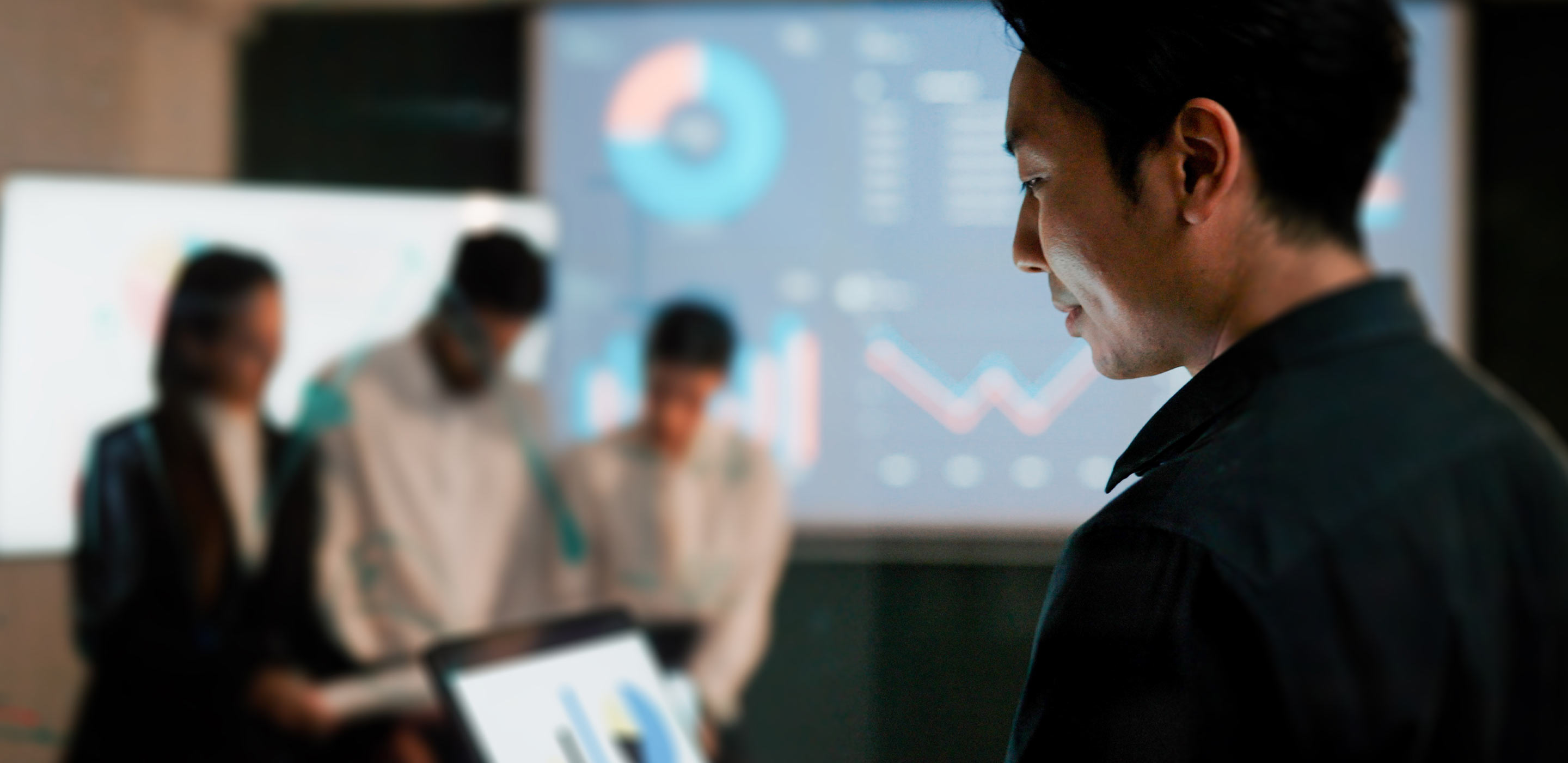 Colleagues in meeting room discussing data