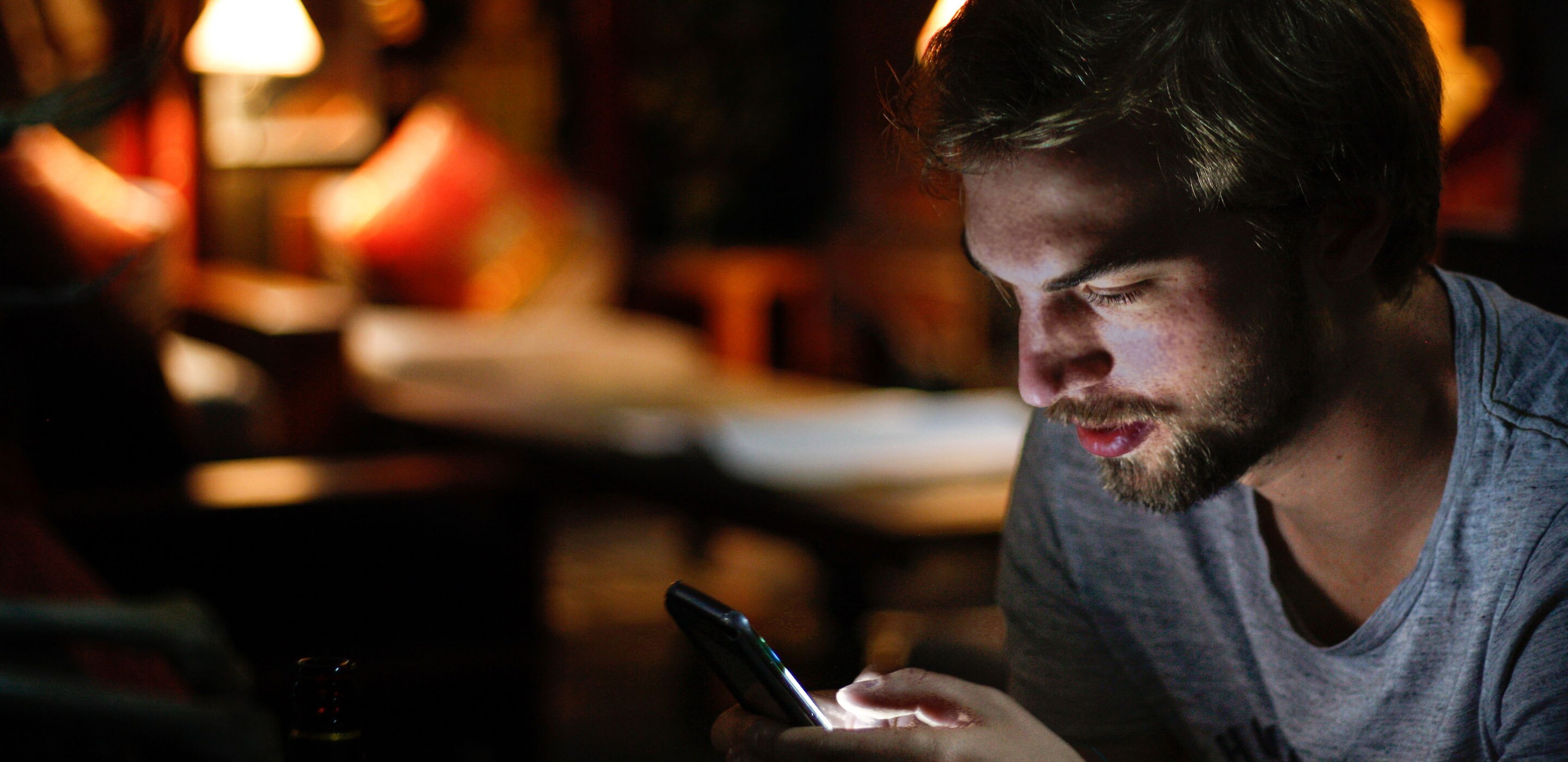 A man focusing on his cellphone