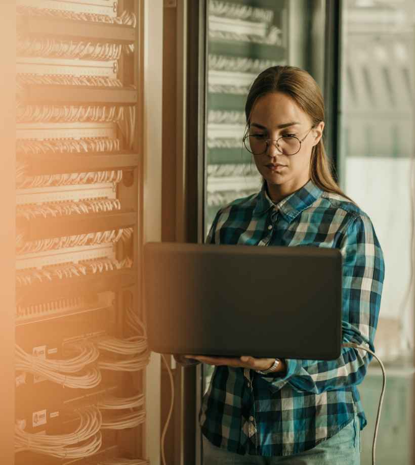 A woman typing on a laptop on her feet