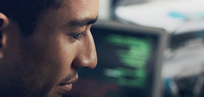 A man in front of a screen with data