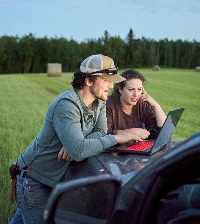 Male and female working on a laptop