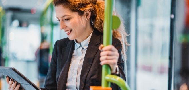 Woman standing and looking at a tablet device