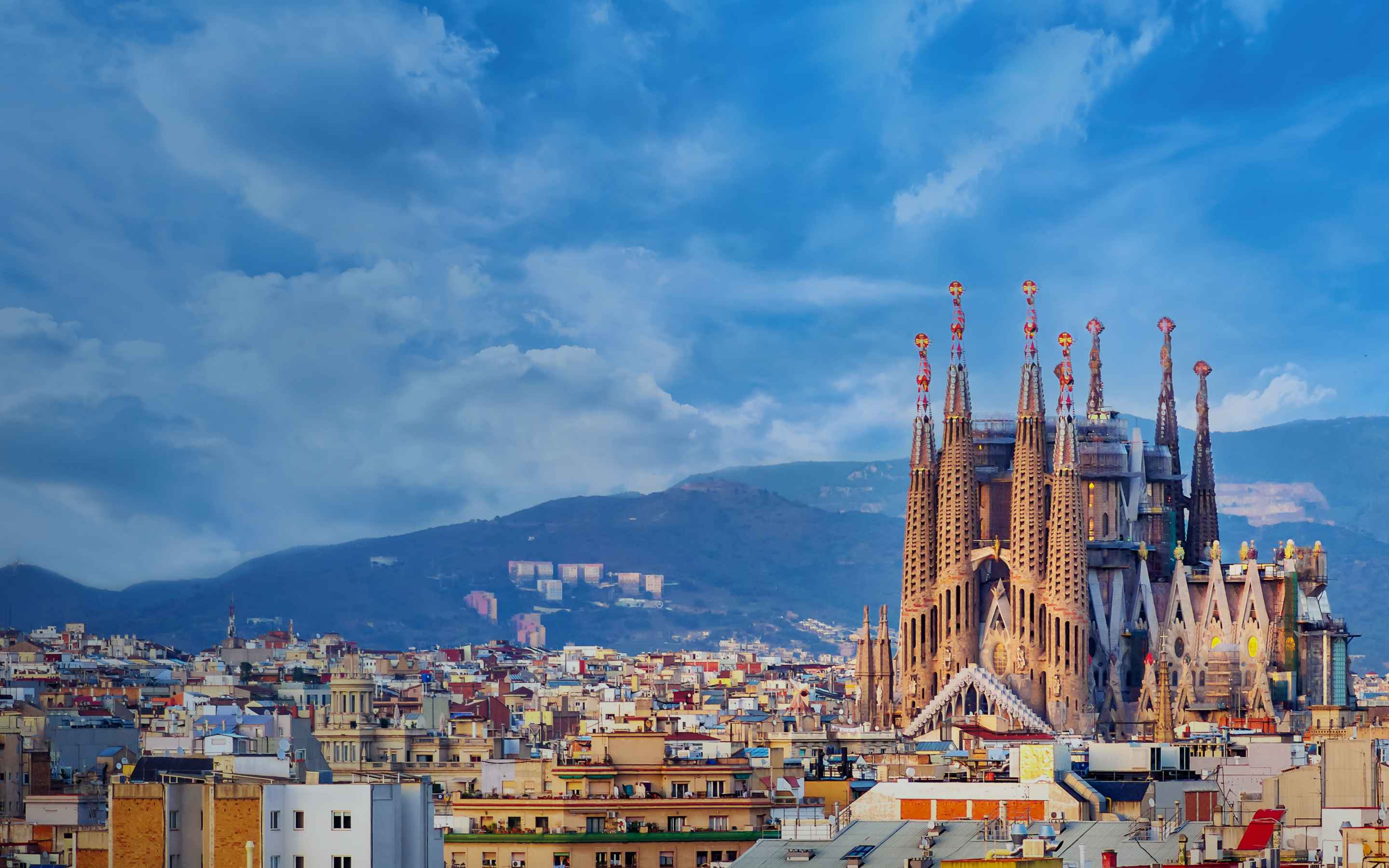 Barcelona buildings with clear sky and a mountain behind