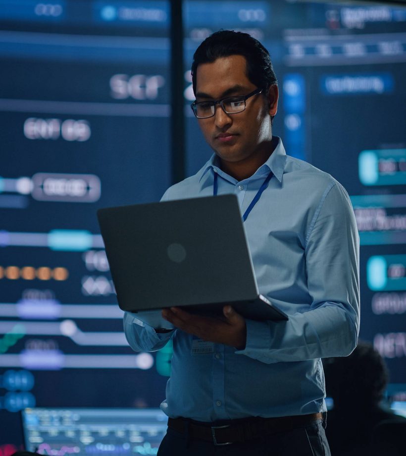 Man standing working on his laptop