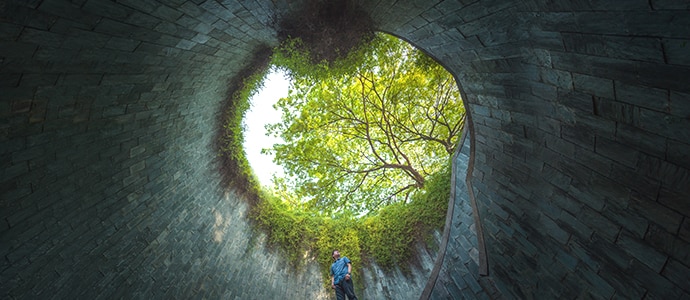 Man looking at the outside from inside a underground building