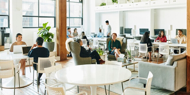 An open plan office with colleagues collaborating