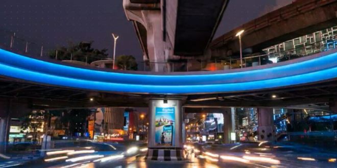 Street at night with a brightly lit arc overhead