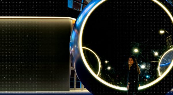 Woman standing at a large circular object