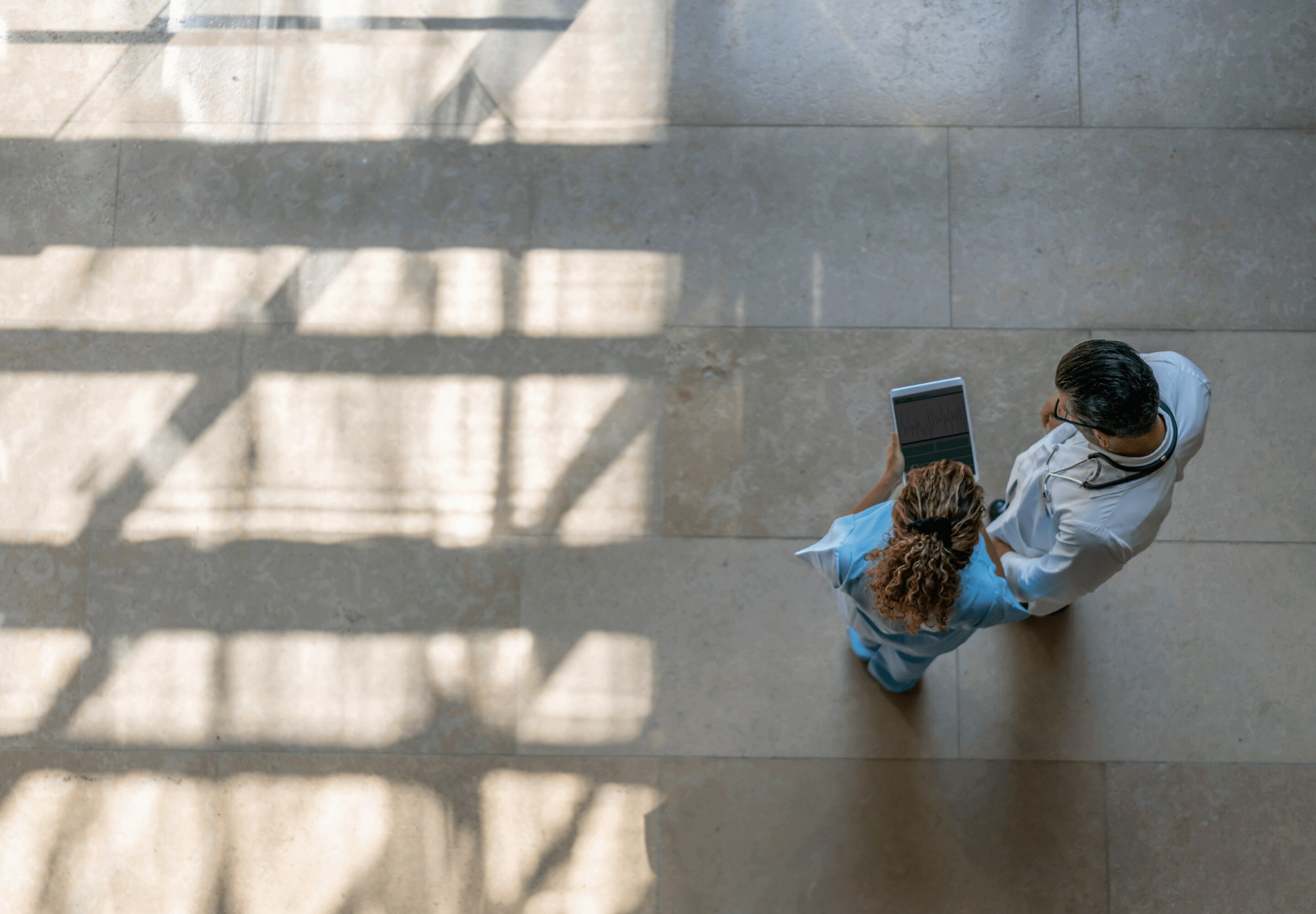 Healthcare professionals holding a tablet