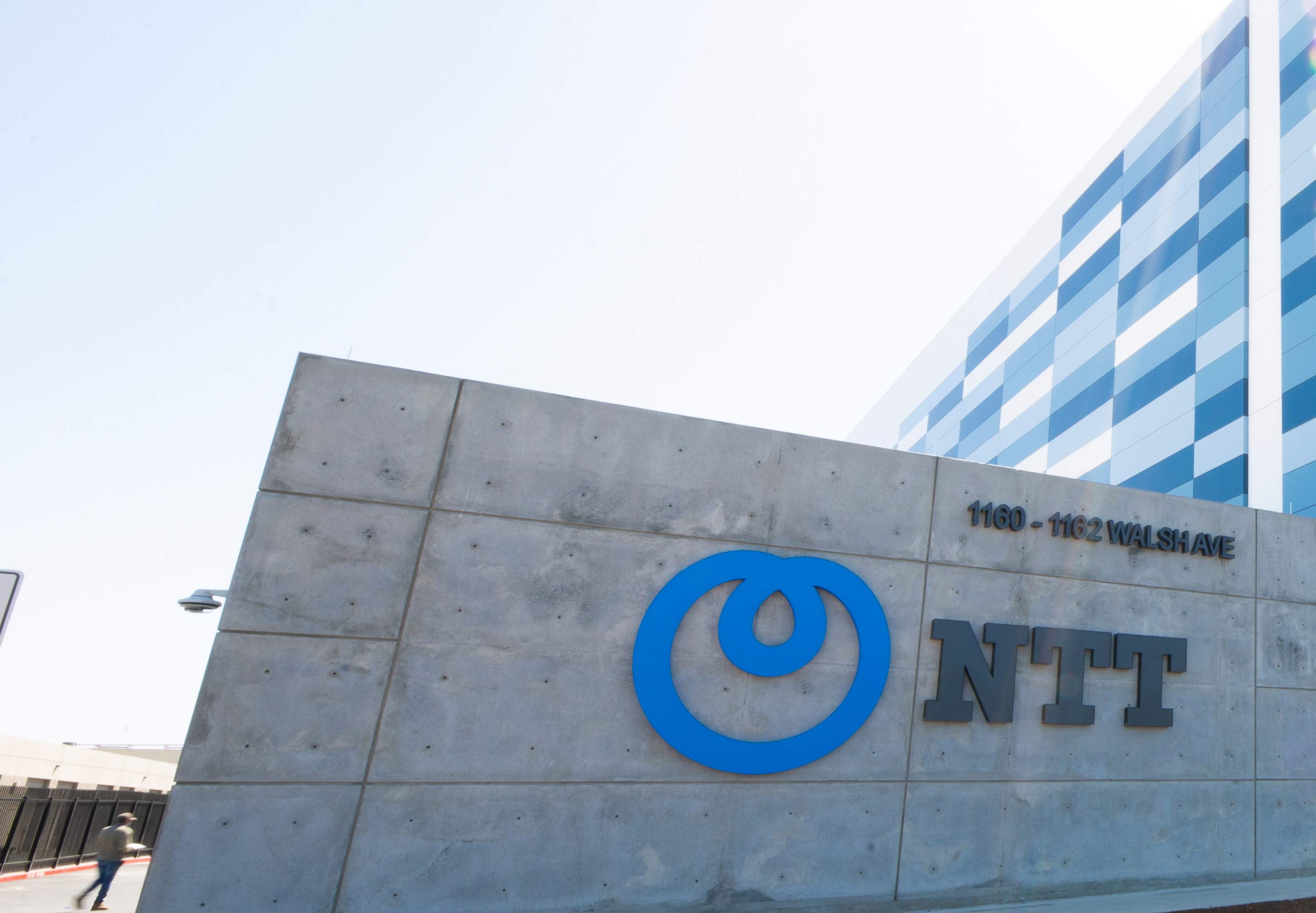 NTT logo on a grey wall