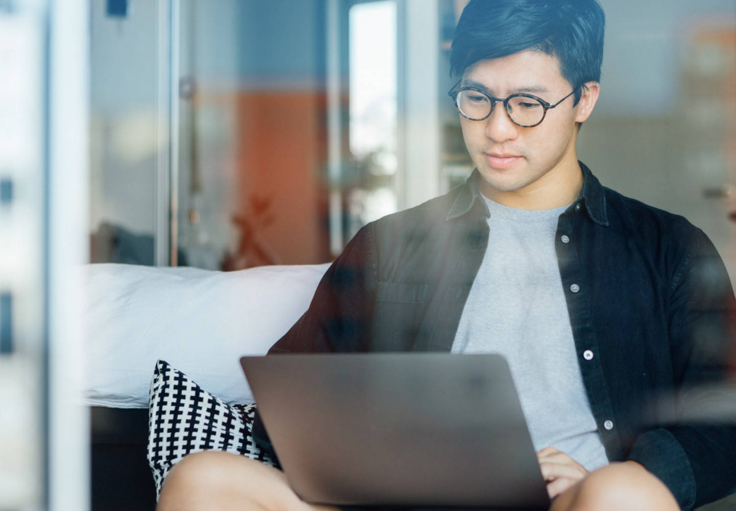 Man on couch using laptop