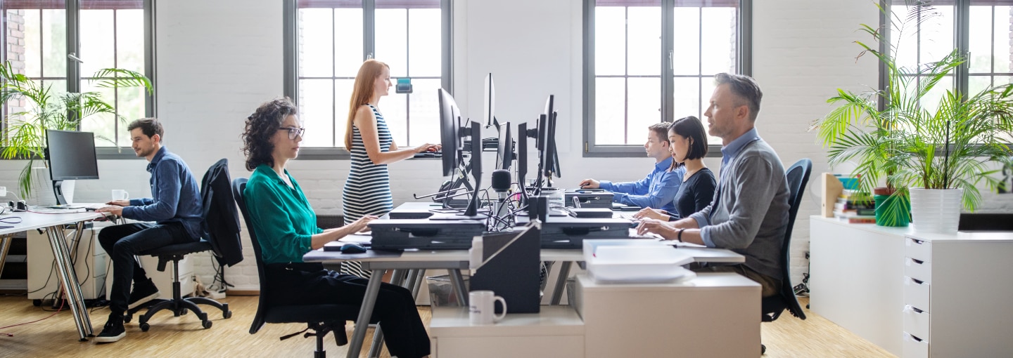 People sitting at their desks working on computers