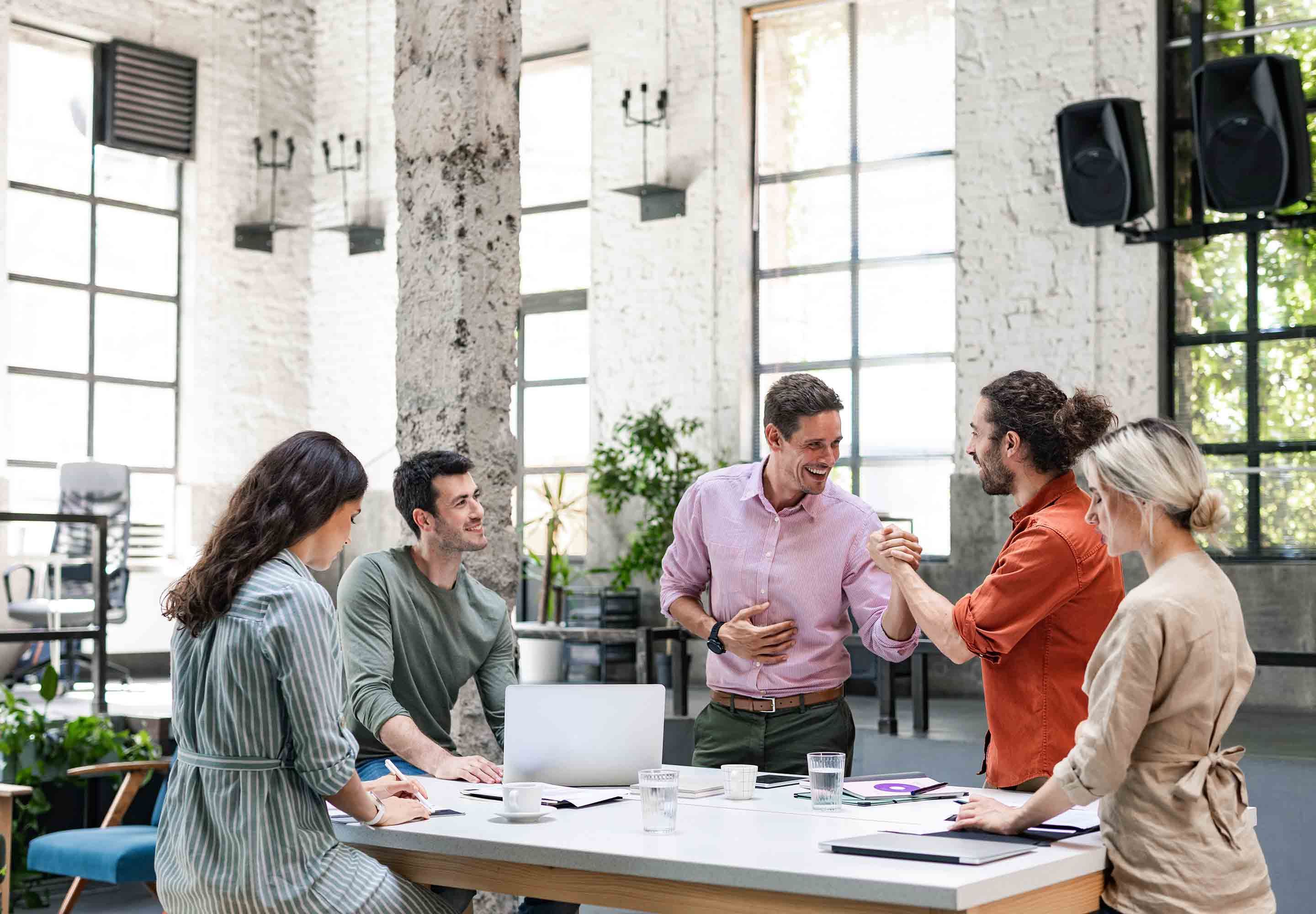 A group of people having a discussion around the table