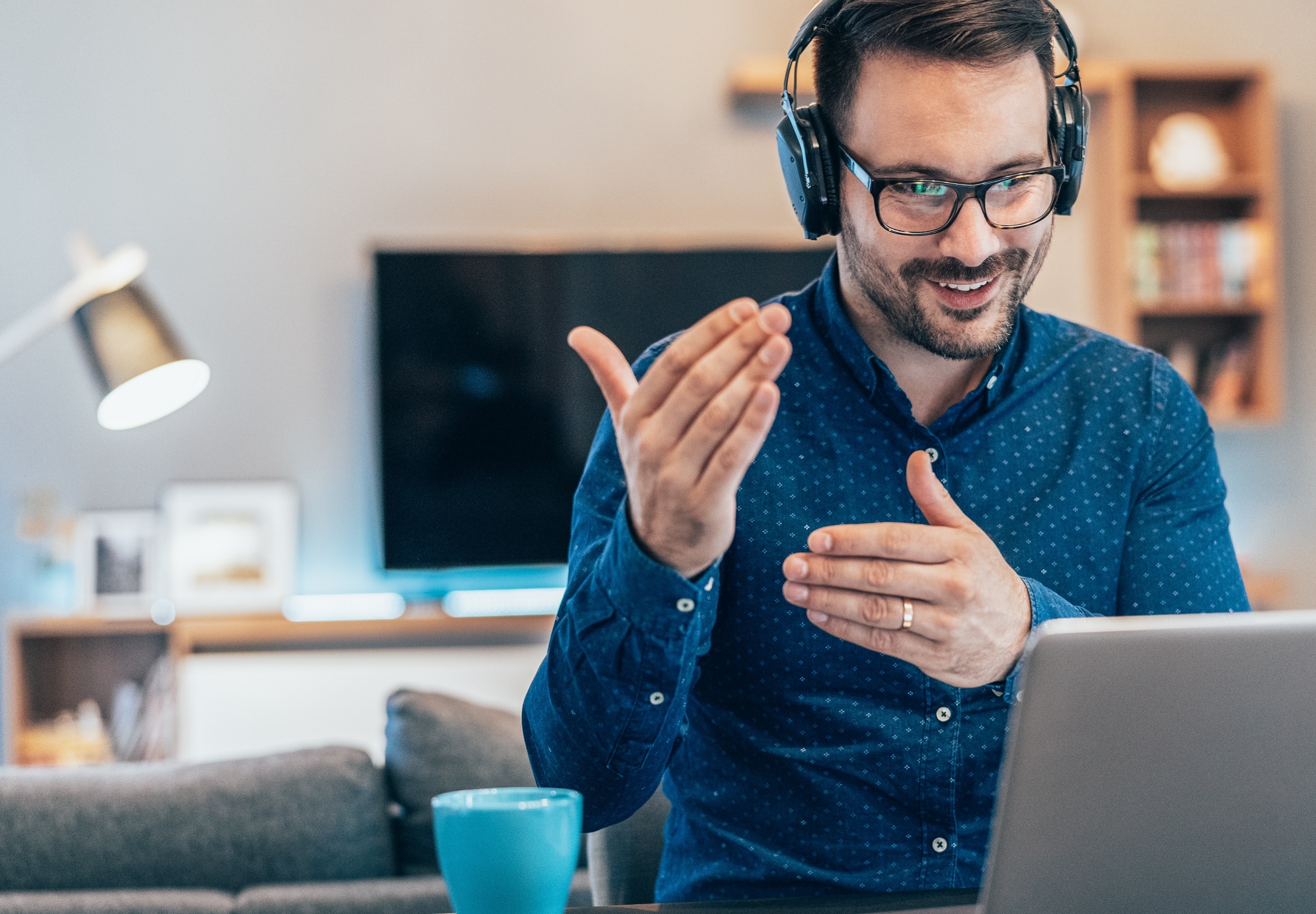 Man in blue shirt in a virtual meeting