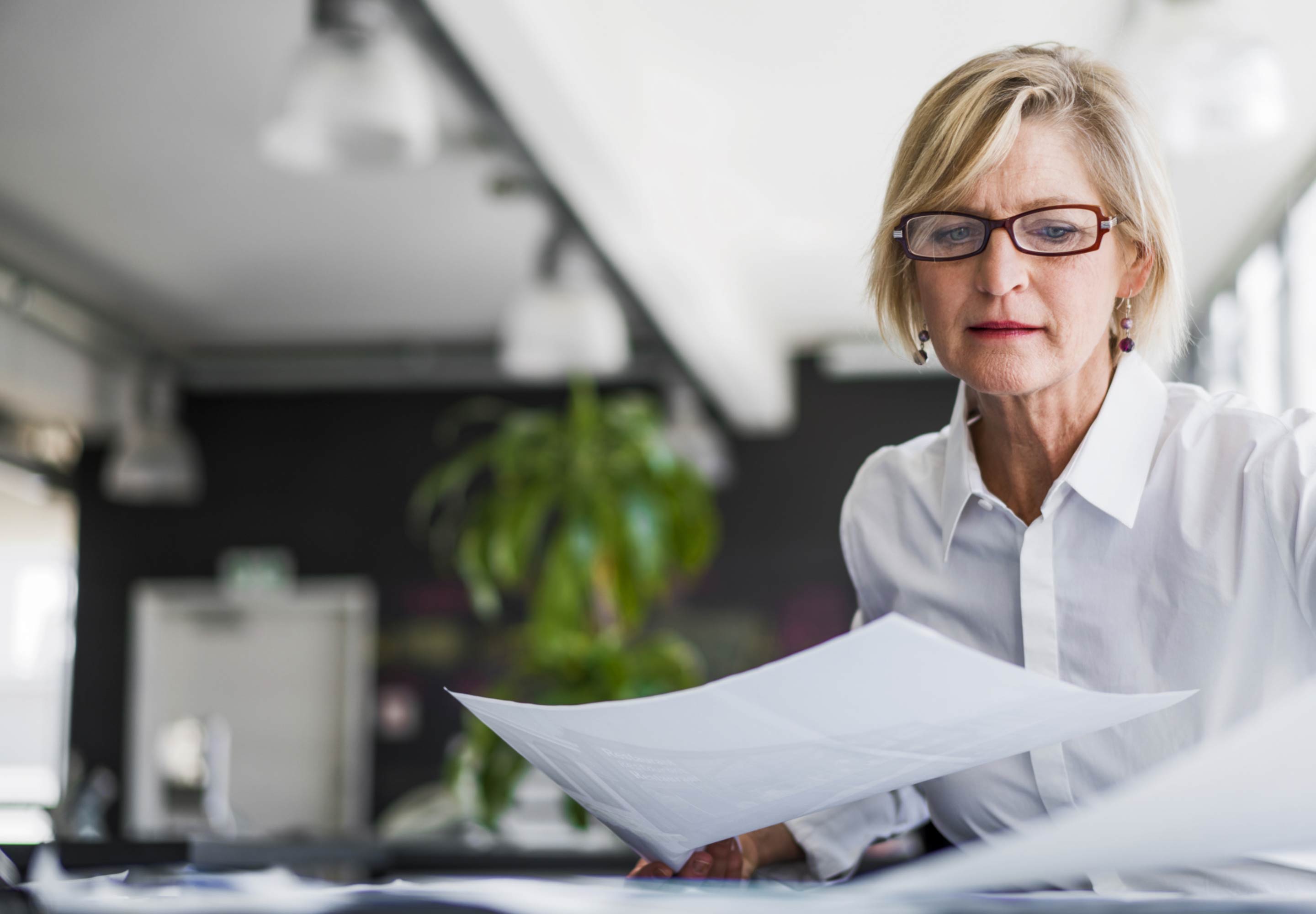 Lady in white shirt holding a document