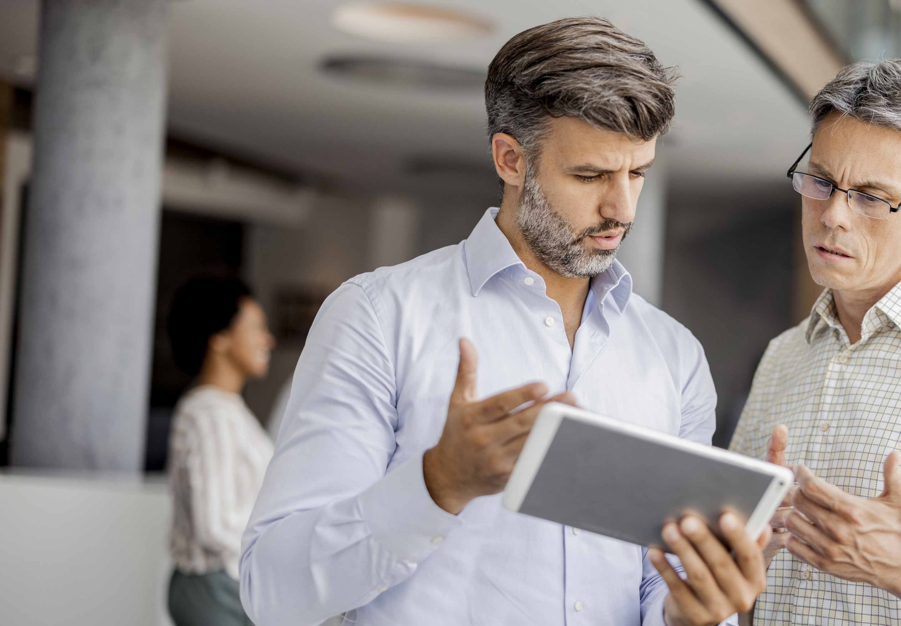 Two man looking at a tablet screen