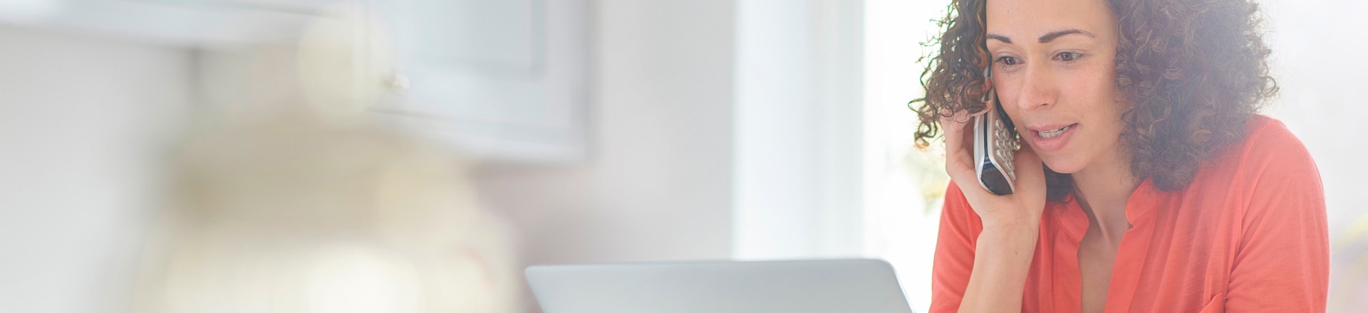 A woman on the phone as she works from home