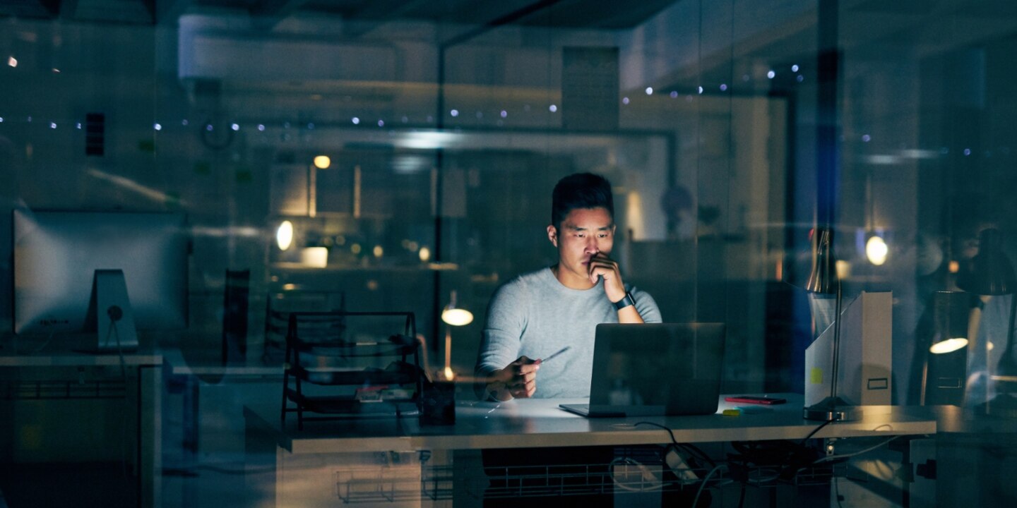 A man working on his laptop at night