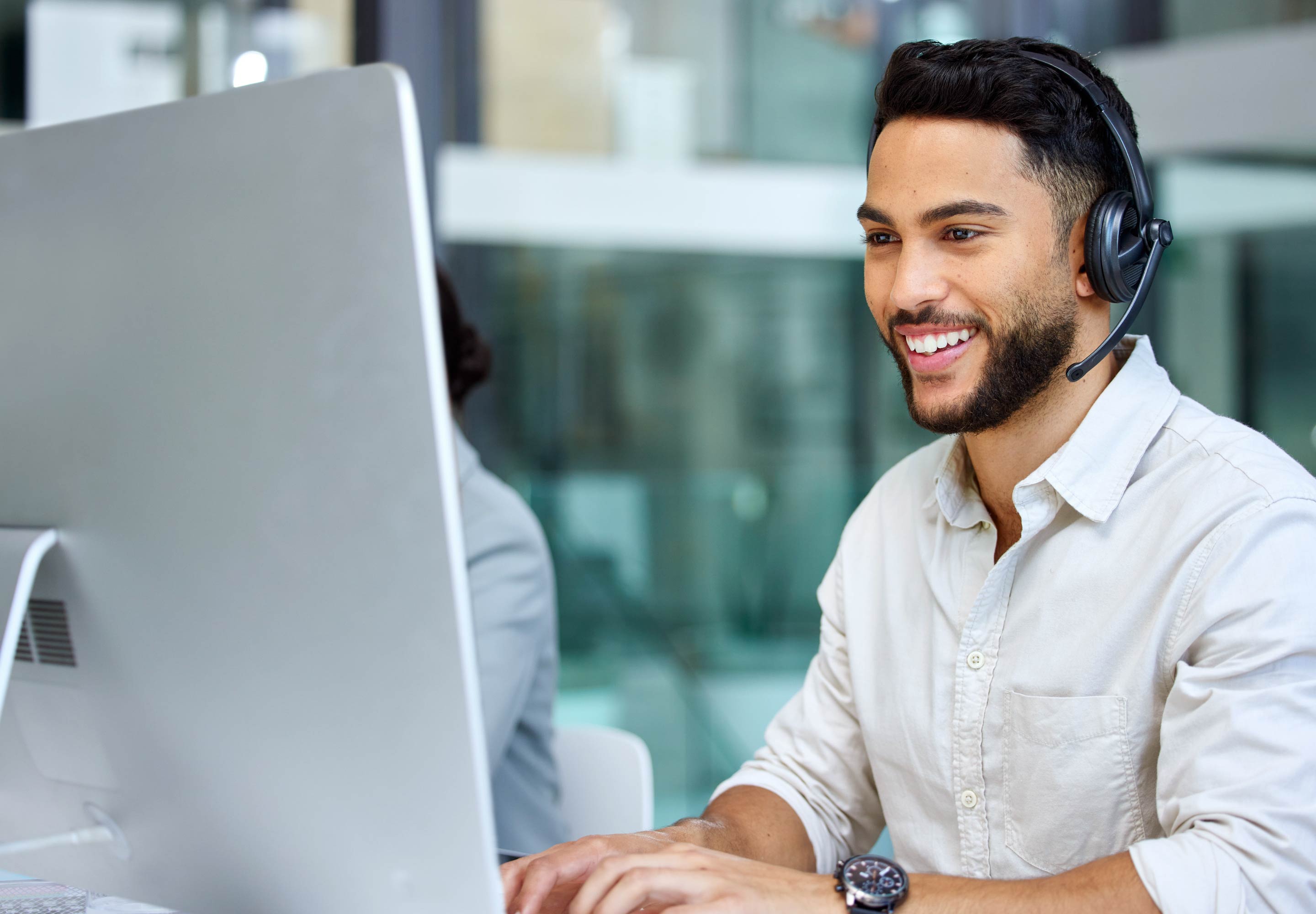 Man looking at a big monitor