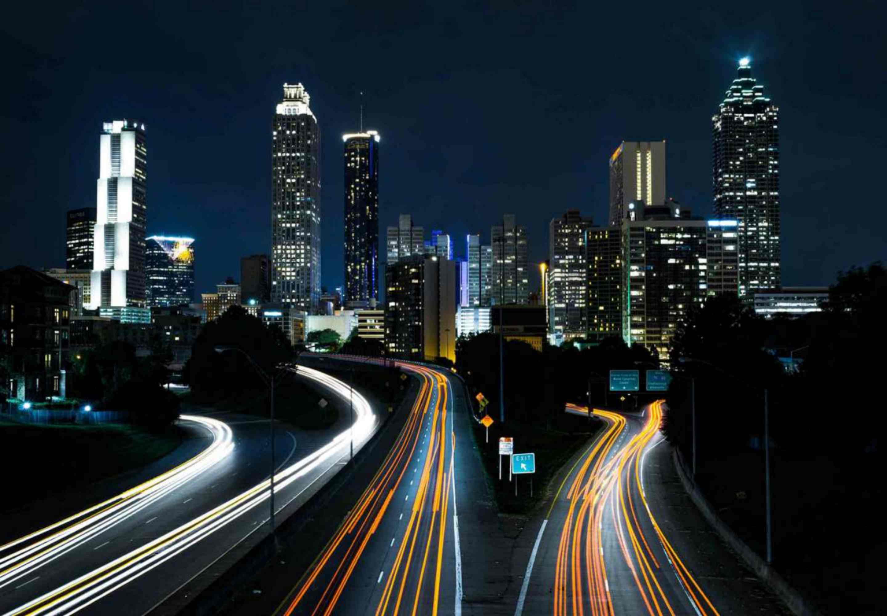 Tall buildings with lights and streets with lights