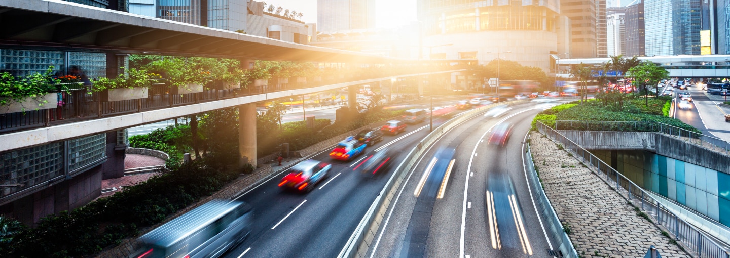 Cars on a highway with light shining in the distance
