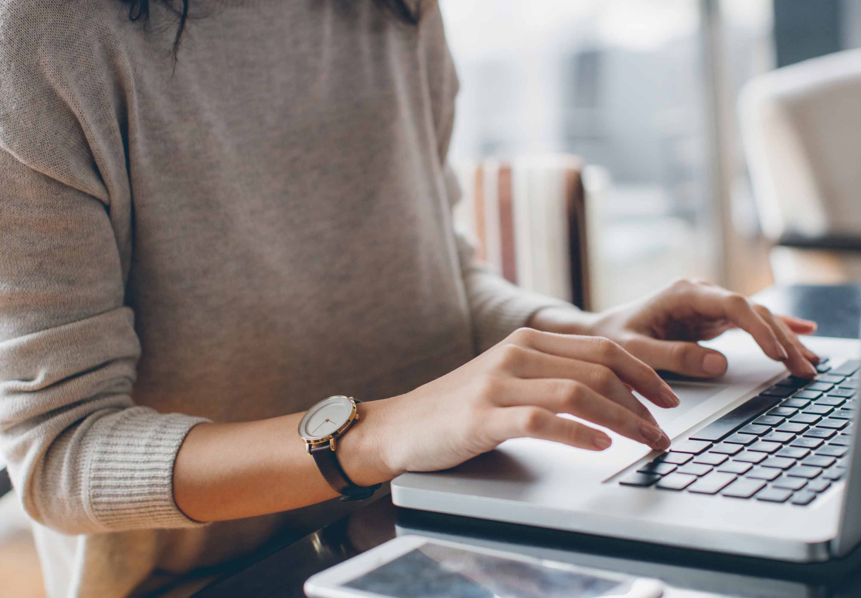 Business professional typing on the laptop
