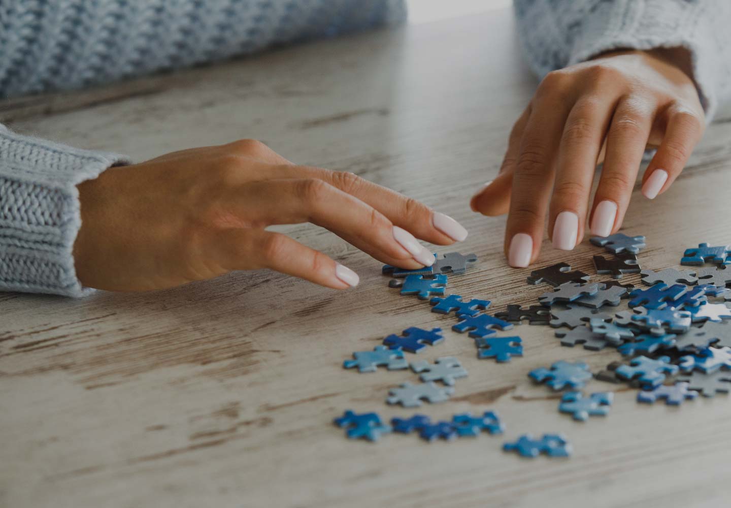 Hands looking through puzzle pieces