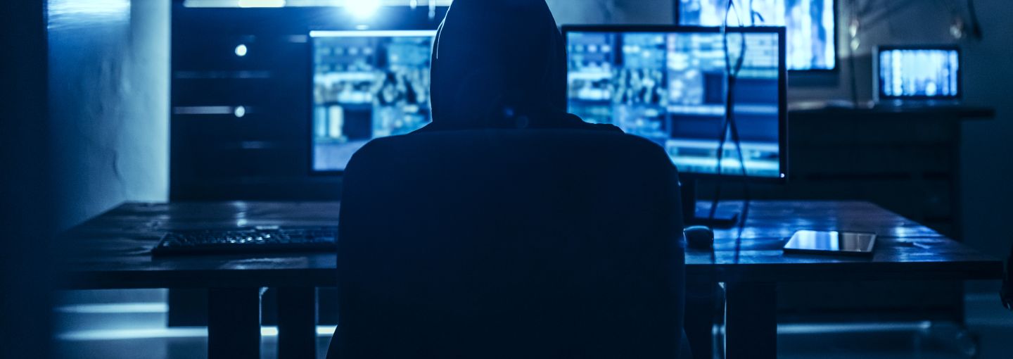 A person sitting in front of computer screens