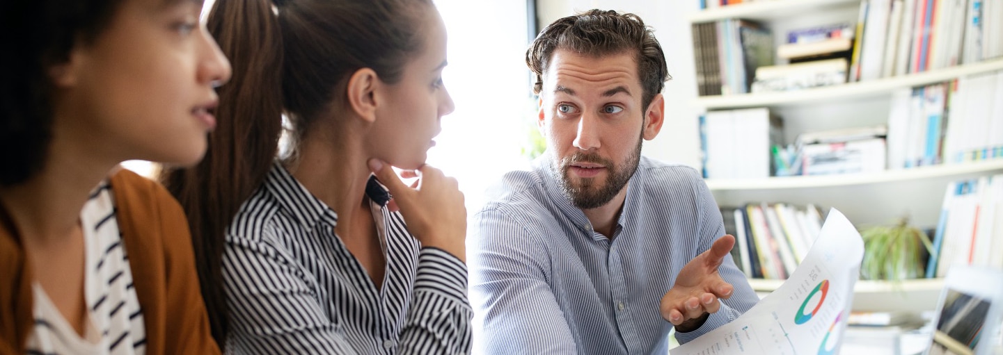 Colleagues discussing analytics report