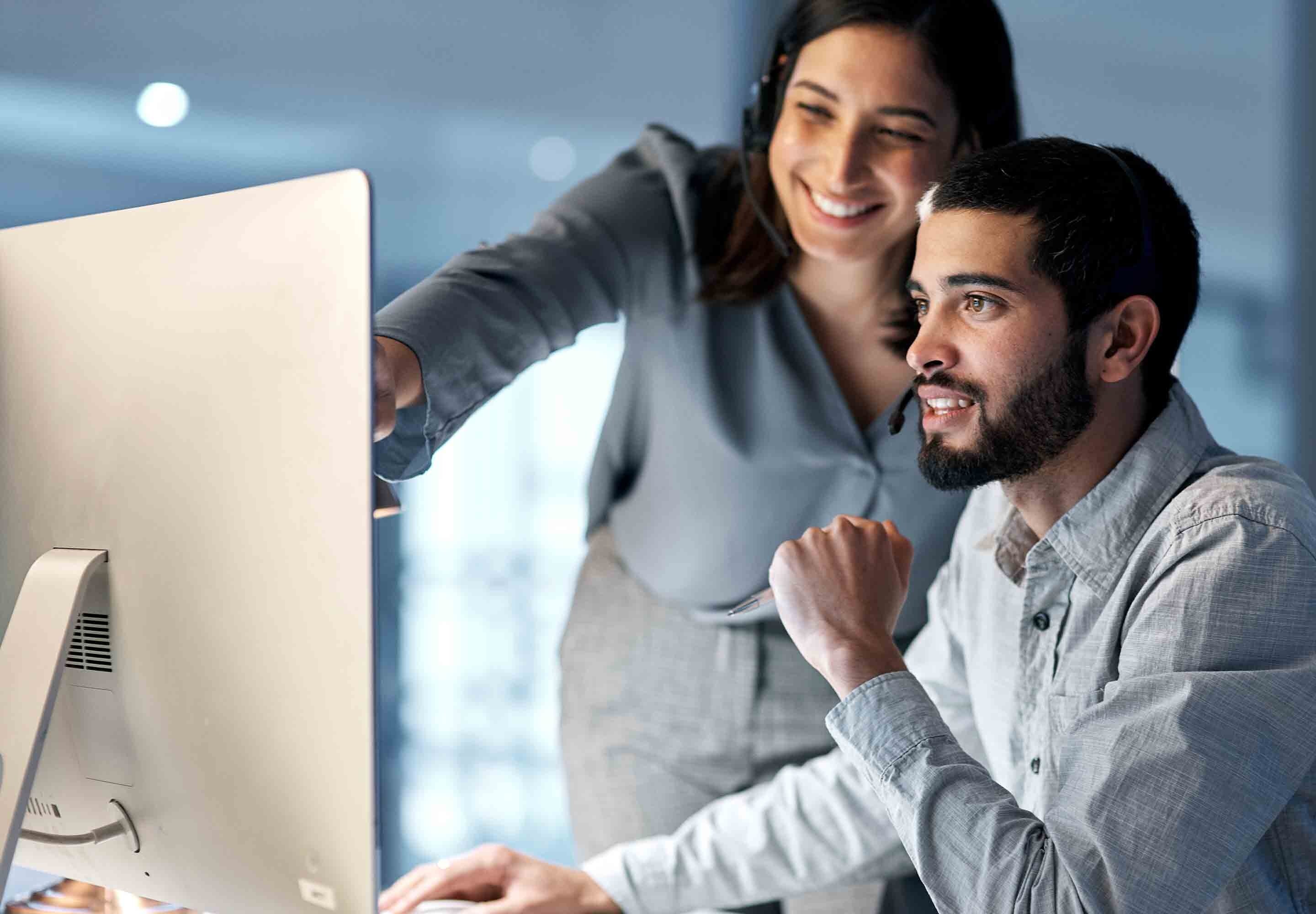 Business professionals looking at the computer screen