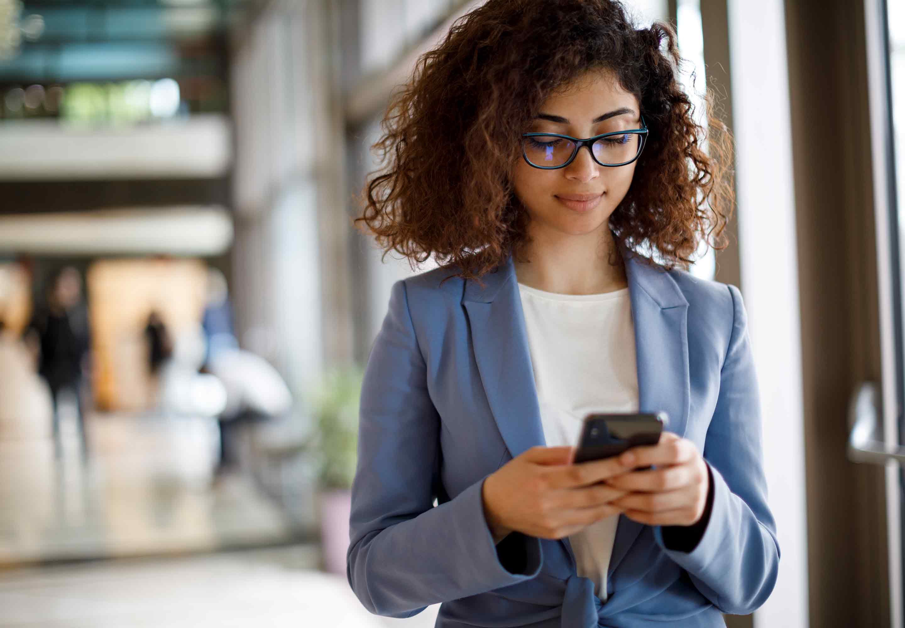 Business professional holding a mobile phone