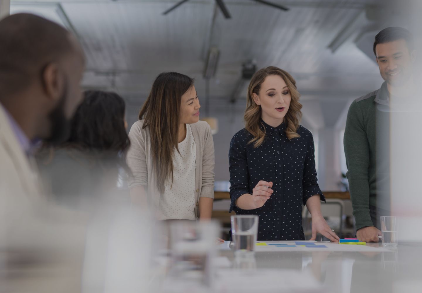 Group of people standing around a table