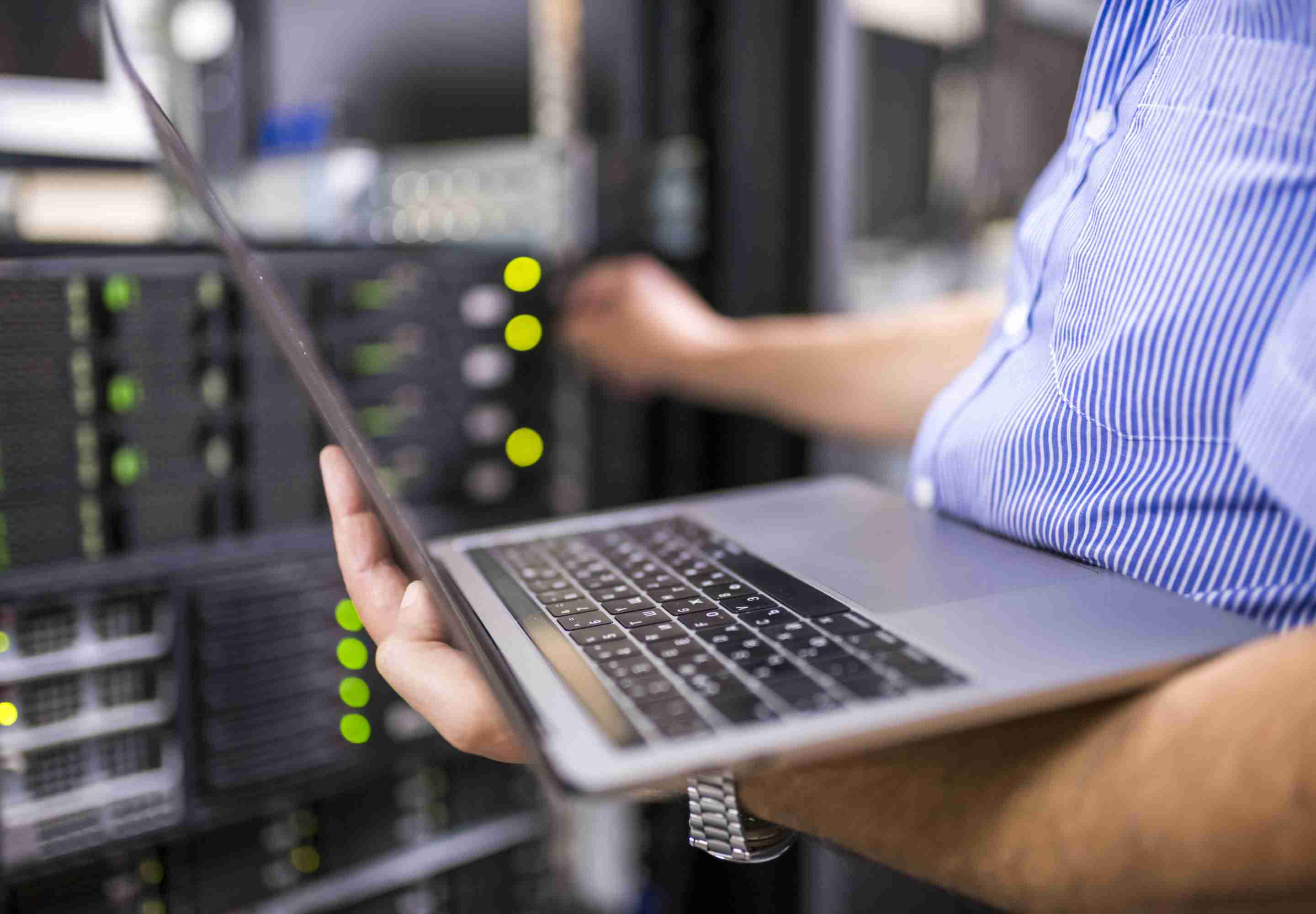 A laptop opened in a server room