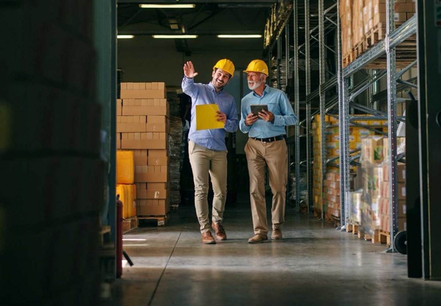 Two man in a hardware wearing protective heats