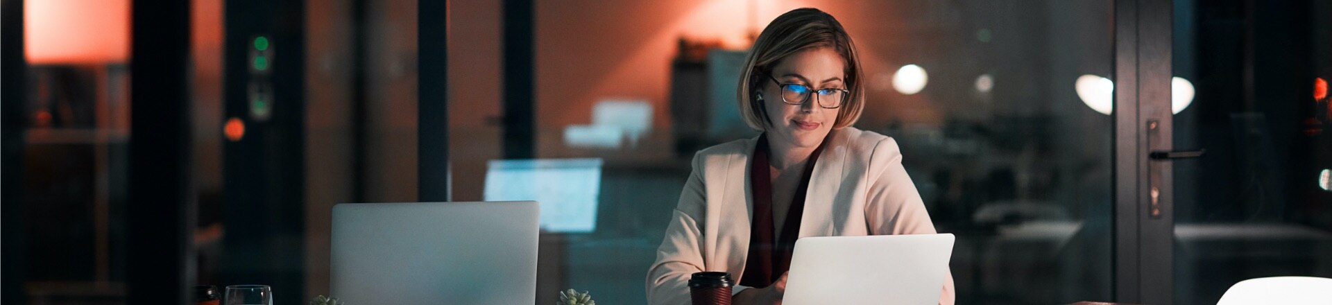 A woman working on her laptop at night