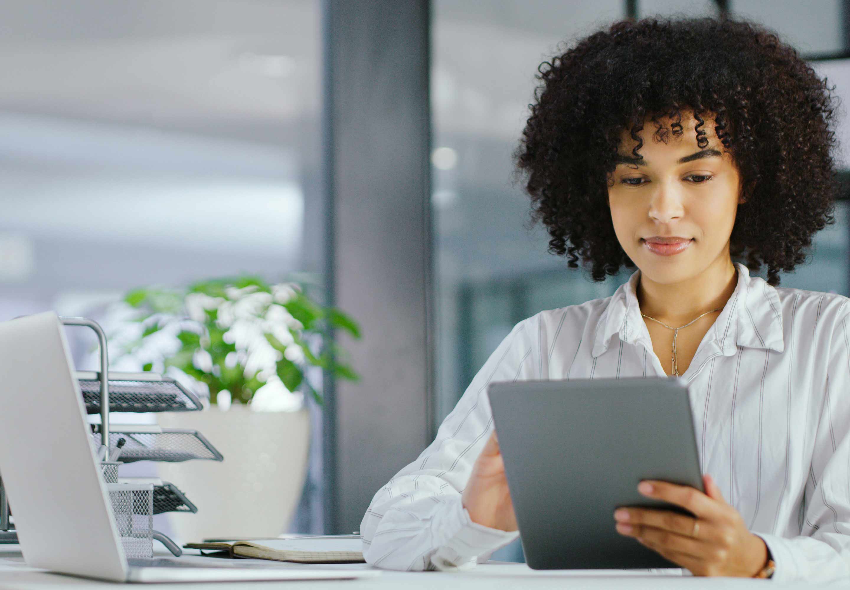 A woman touching a tablet screen