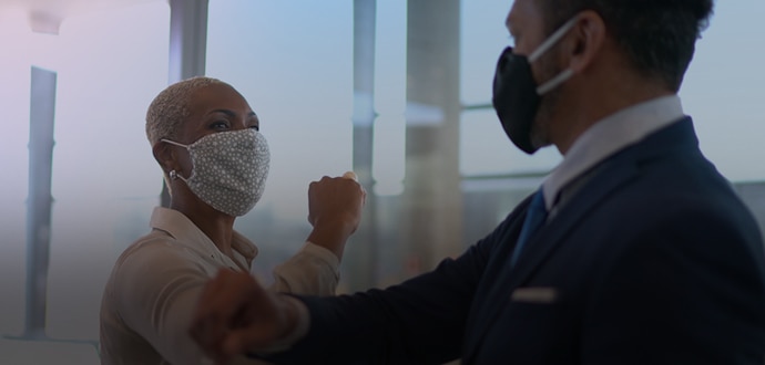 Colleagues greeting with elbow