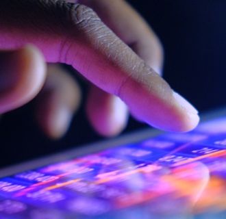 Finger reaching out to touch a mobile device screen