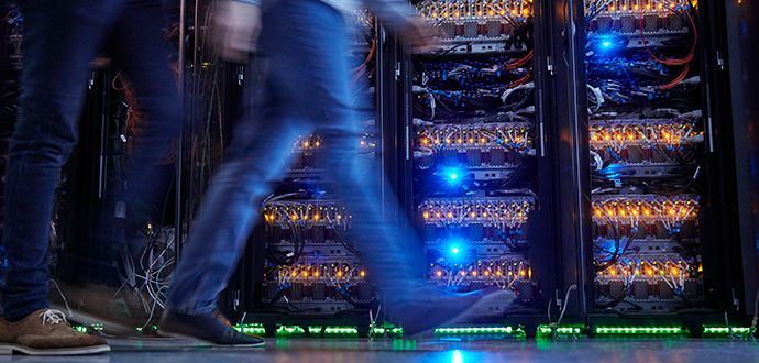 Legs walking past network hardware