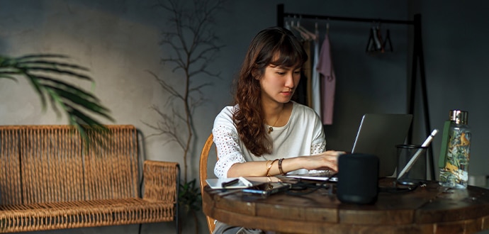 Woman sitting at a desk working on her laptop
