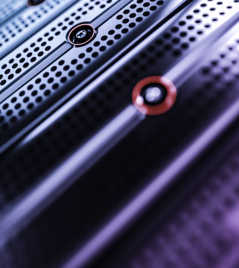 A black object with small holes and a red circle