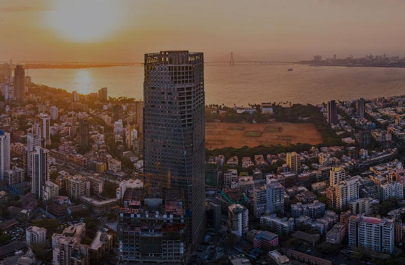 A tall building surrounded by other buildings