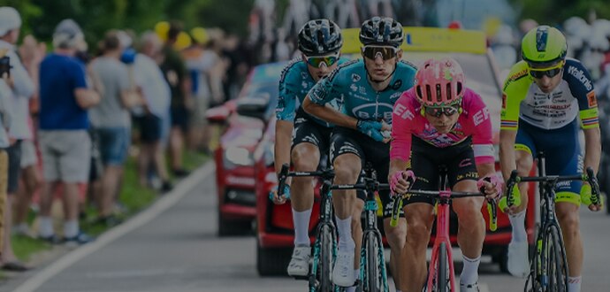 Racers on the road with cars behind