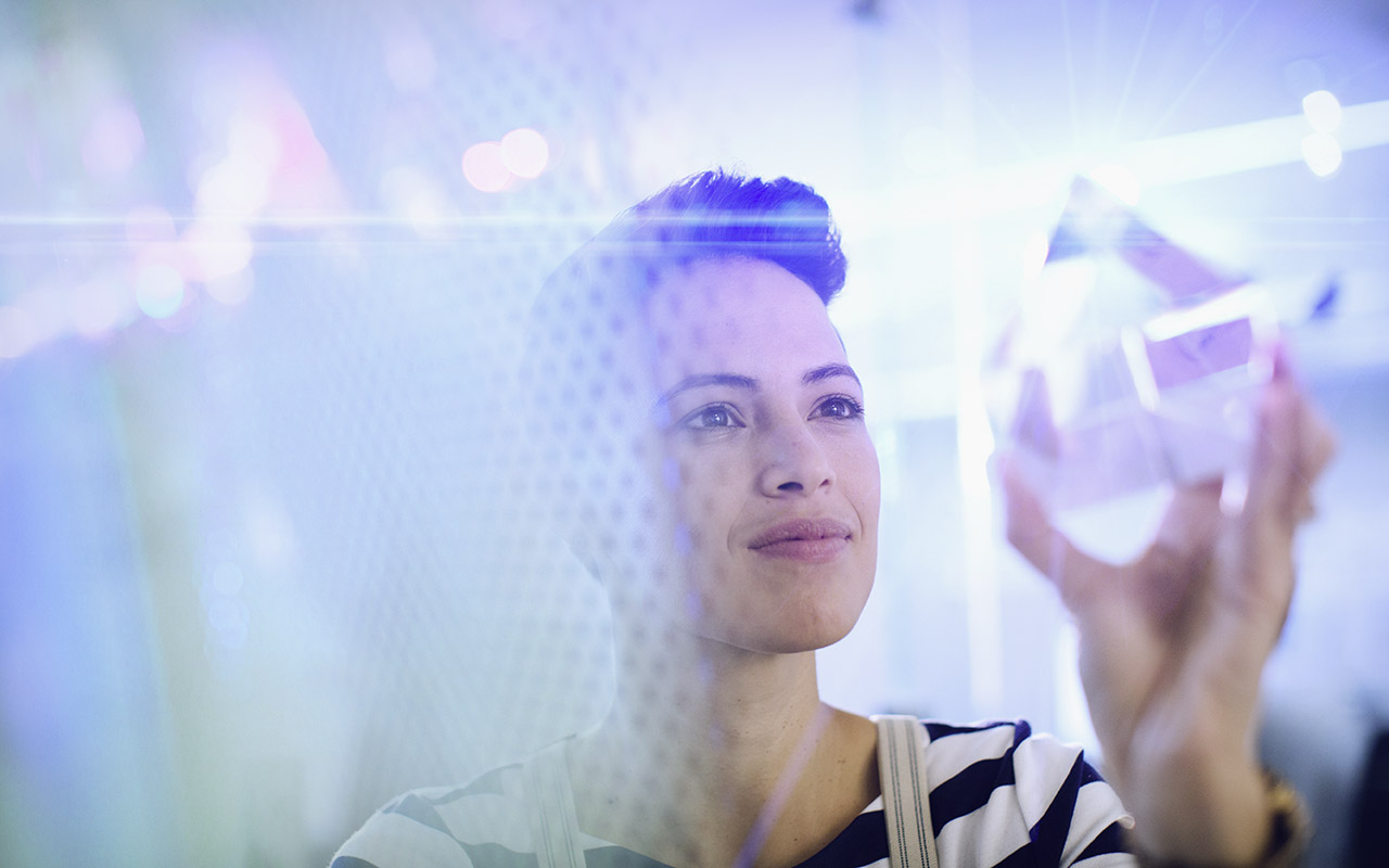 Woman looking at a glass prism