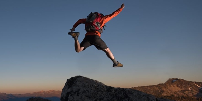 Man jumping between boulders