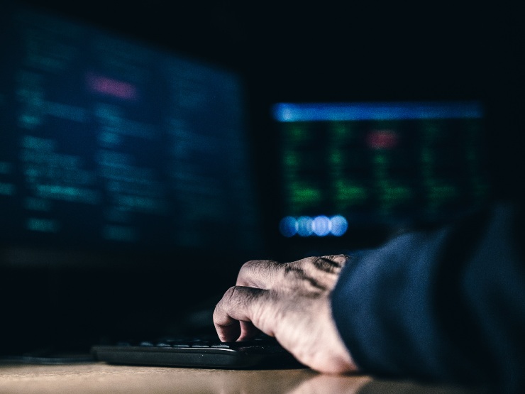 A person typing on a laptop