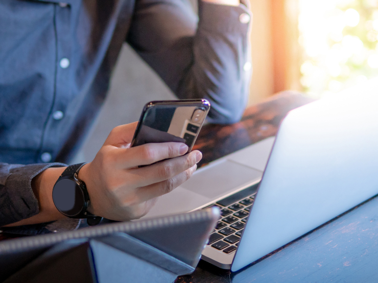 A man with his laptop and phone