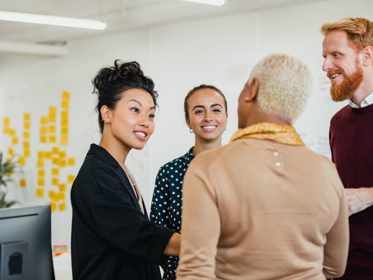 Colleagues having a chat in a bright, sunny office